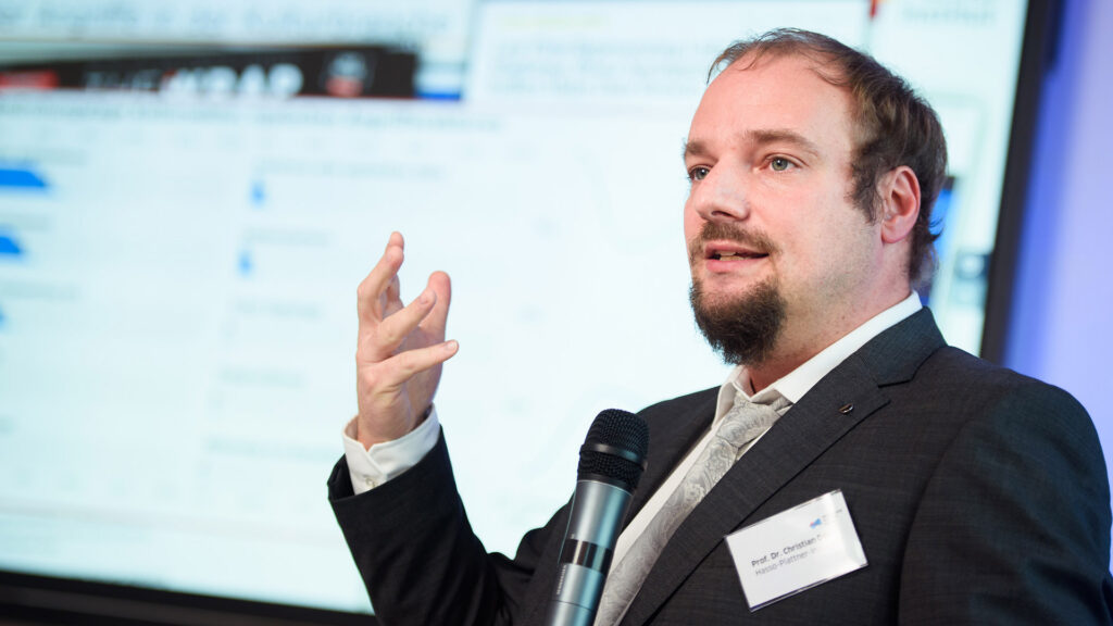 Prof. Dr. Christian Dörr hebt die Hand beim Vortrag auf der 3. kulturBdigital Konferenz 2020.